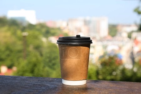 Photo for Paper cup with hot cofffee outdoors. Takeaway drink - Royalty Free Image
