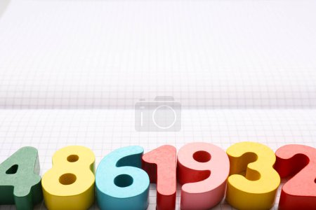 Photo for Colorful numbers on notebook with grid pages. Space for text - Royalty Free Image