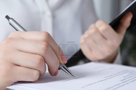 Photo for Woman signing document at table in office, closeup - Royalty Free Image