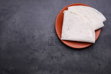 Photo for Delicious folded Armenian lavash on dark table, top view. Space for text - Royalty Free Image