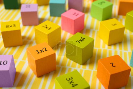 Photo for Colorful cubes with numbers and multiplications on yellow background - Royalty Free Image