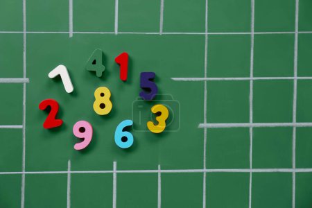 Photo for Many colorful numbers on green chalkboard, flat lay - Royalty Free Image