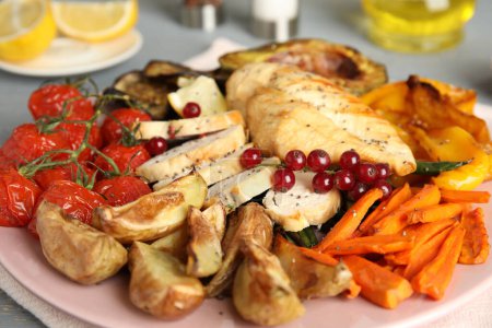 Photo for Tasty cooked chicken fillet and vegetables on table, closeup. Healthy meals from air fryer - Royalty Free Image
