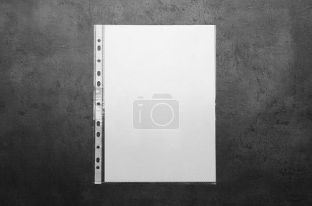 Foto de Punched pocket with paper sheet on grey background top view - Imagen libre de derechos