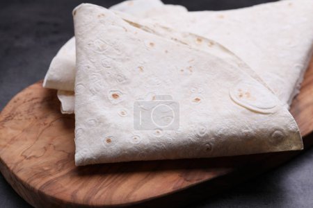 Photo for Delicious folded Armenian lavash on dark table, closeup - Royalty Free Image