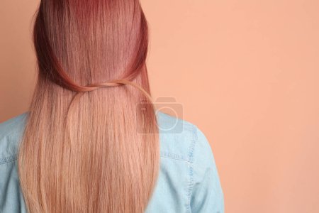 Photo for Woman with bright dyed hair on pale pink background, back view. Space for text - Royalty Free Image