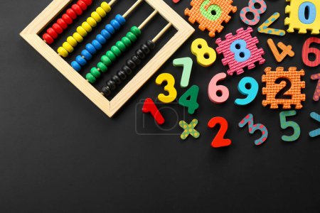 Photo for Many colorful numbers and mathematical symbols near abacus on black background, flat lay. Space for text - Royalty Free Image