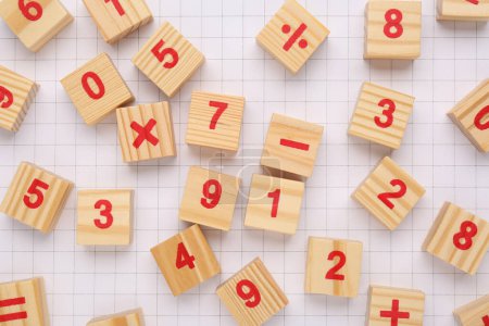 Photo for Wooden cubes with mathematical symbols and numbers on sheet of grid paper, flat lay - Royalty Free Image