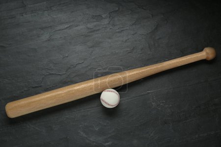 Photo for Baseball bat and ball on black background, top view. Sports equipment - Royalty Free Image