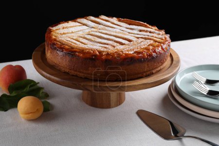 Foto de Sabroso pastel de albaricoque con azúcar en polvo en la mesa - Imagen libre de derechos