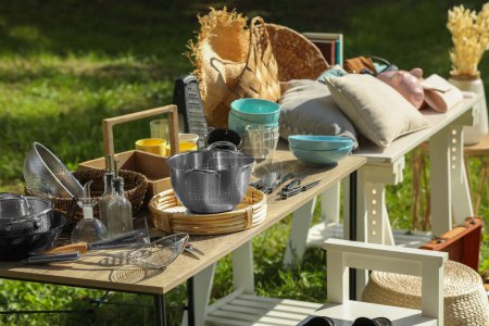 Foto de Small tables with many different items on garage sale outdoors - Imagen libre de derechos