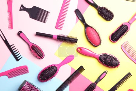 Téléchargez les photos : Different hair brushes and combs on color background, flat lay - en image libre de droit