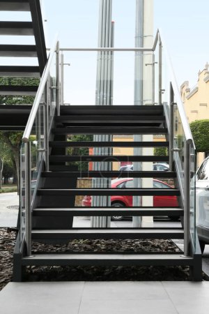 Modern stairs with metal handrailings on city street