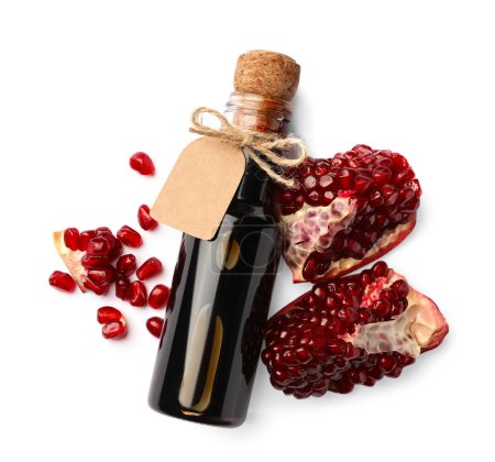 Bottle of pomegranate sauce and fresh ripe fruit on white background, top view