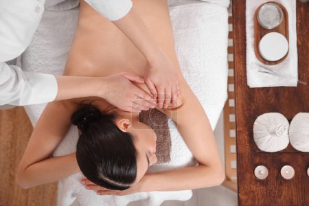 Foto de Young woman having professional massage in spa salon, top view - Imagen libre de derechos