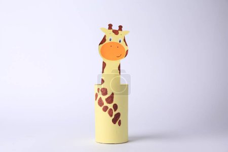 Foto de Toy giraffe made from toilet paper hub on white background. Children's handmade ideas - Imagen libre de derechos