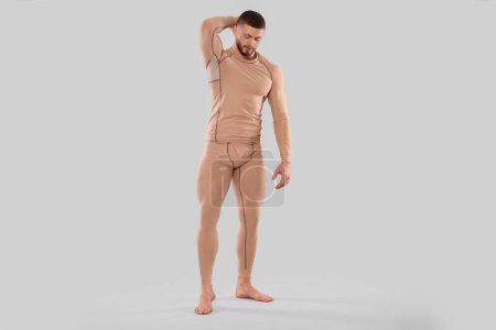 Téléchargez les photos : Man in warm thermal underwear on light background. Space for text - en image libre de droit