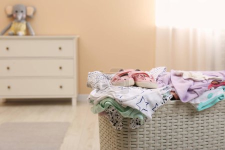 Photo for Laundry basket with baby clothes in child room, closeup. Space for text - Royalty Free Image
