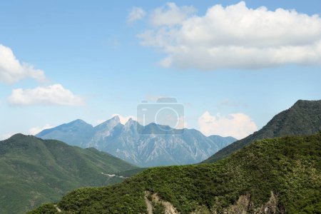 Photo for Picturesque view of big mountains and trees under cloudy sky - Royalty Free Image