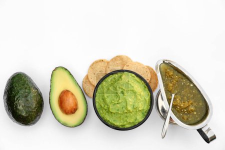 Photo for Delicious guacamole made of avocados and nachos on white background, top view - Royalty Free Image