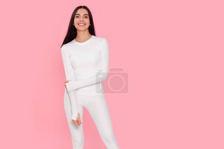 Téléchargez les photos : Woman in warm thermal underwear on pink background. Space for text - en image libre de droit