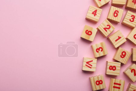 Photo for Wooden cubes with numbers and mathematical symbols on pink background, flat lay. Space for text - Royalty Free Image