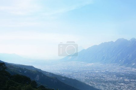 Photo for Big city between mountains under sky on sunny day - Royalty Free Image