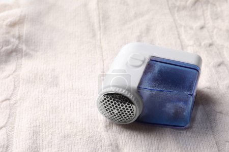 Photo for Fabric shaver with fuzz on knitted cloth, closeup. Space for text - Royalty Free Image