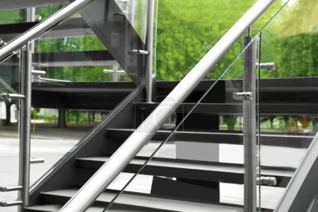 Modern stairs with metal handrailings on city street