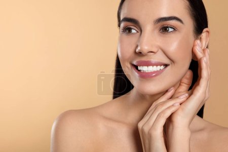 Photo for Portrait of attractive young woman on beige background, space for text. Spa treatment - Royalty Free Image