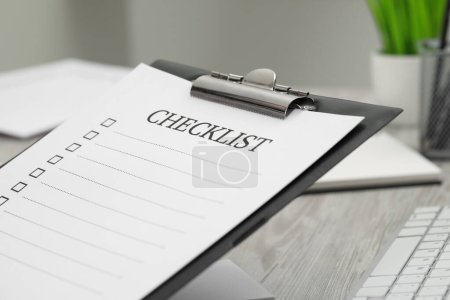 Photo for Clipboard with inscription Checklist indoors, closeup view - Royalty Free Image