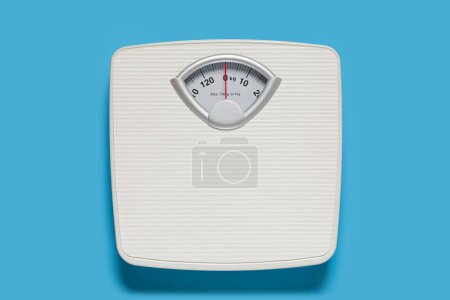 Photo for Bathroom scale on light blue background, top view - Royalty Free Image