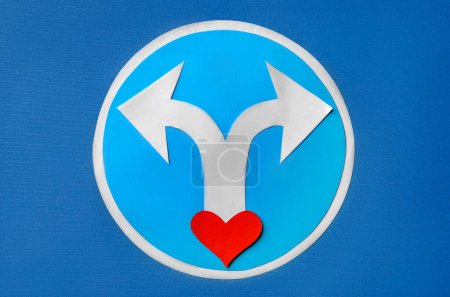 Divorce concept. Paper heart and arrows on blue background, flat lay