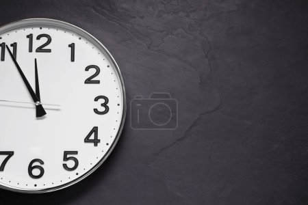 Photo for Clock showing five minutes until midnight on black table, top view with space for text. New Year countdown - Royalty Free Image