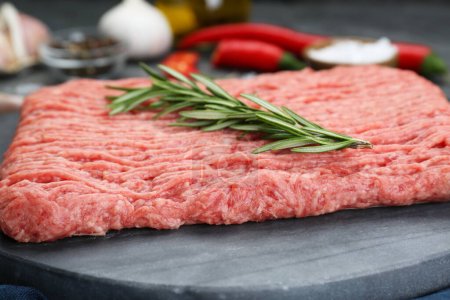 Raw fresh minced meat with rosemary, closeup