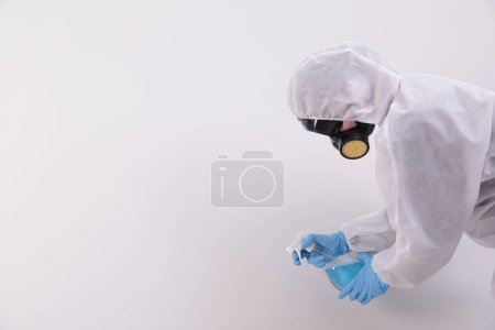 Photo for Woman in protective suit cleaning mold with sprayer on wall. Space for text - Royalty Free Image