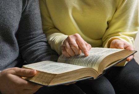 Photo for Couple sitting and reading holy Bible, closeup - Royalty Free Image