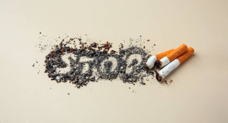 Photo for Word Stop made of cigarette ash and stubs on beige background. Quitting smoking concept - Royalty Free Image