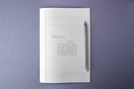 Photo for Word Mistake written with erasable pen in copybook on grey background, top view - Royalty Free Image