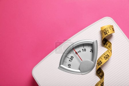 Photo for Weight loss concept. Scales and measuring tape on pink background, top view. Space for text - Royalty Free Image
