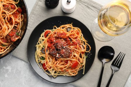 Photo for Delicious pasta with meatballs and tomato sauce served on light grey table, flat lay - Royalty Free Image