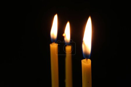 Photo for Burning church candles on dark background, closeup. Space for text - Royalty Free Image