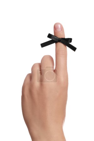 Photo for Woman showing index finger with tied black bow as reminder on white background, closeup - Royalty Free Image