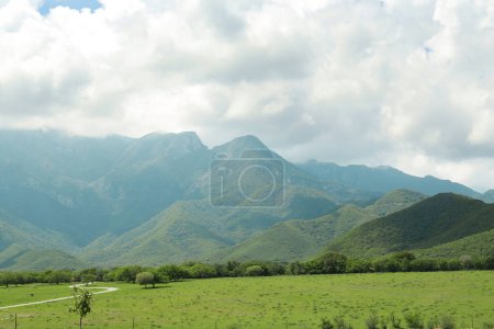 Photo for Picturesque view of mountains and green meadow - Royalty Free Image