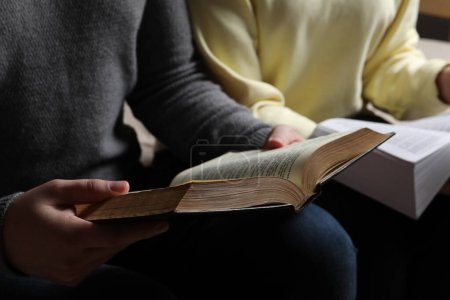 Photo for Couple sitting and reading holy Bibles, closeup - Royalty Free Image