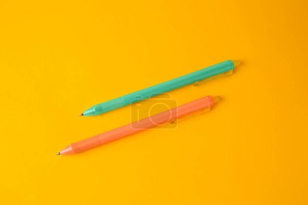 Photo for Two erasable pens on yellow background, flat lay - Royalty Free Image