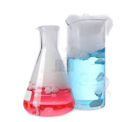Foto de Artículos de vidrio de laboratorio con líquidos de colores y vapor aislado en blanco. Reacción química - Imagen libre de derechos