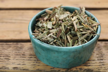 Téléchargez les photos : Bowl with aromatic dried lemongrass on wooden table, closeup - en image libre de droit