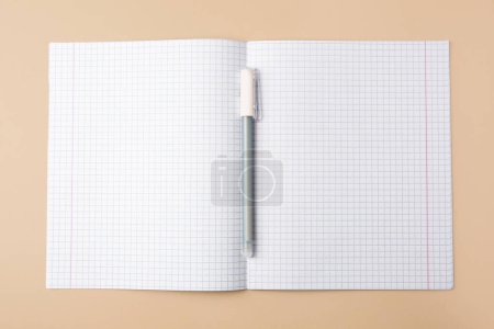Photo for Copybook with erasable pen on beige background, top view - Royalty Free Image