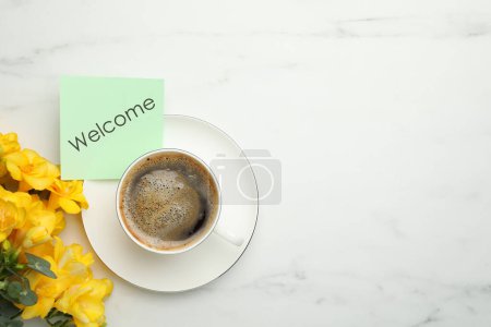 Téléchargez les photos : Welcome card, beautiful yellow freesia flowers and cup of aromatic coffee on white marble table, flat lay - en image libre de droit